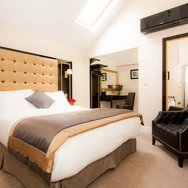 Gold and Black Boutique Hotel Bedroom with Large Deep Buttoned Headboard