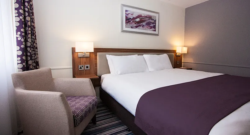 Holiday inn double hotel bedroom with wooden headboard