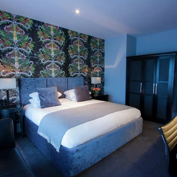 Dark Hotel Bedroom with Feature Wall Covering