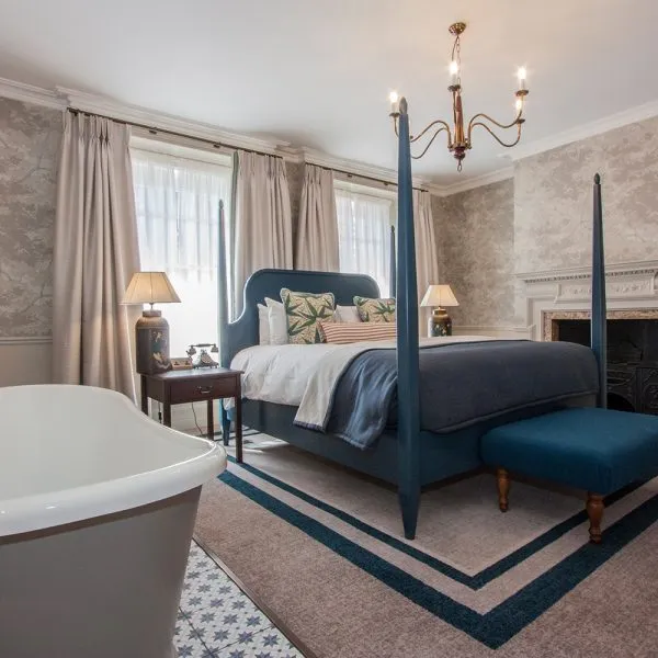 bespoke bedroom design of hotel blue four poster bed